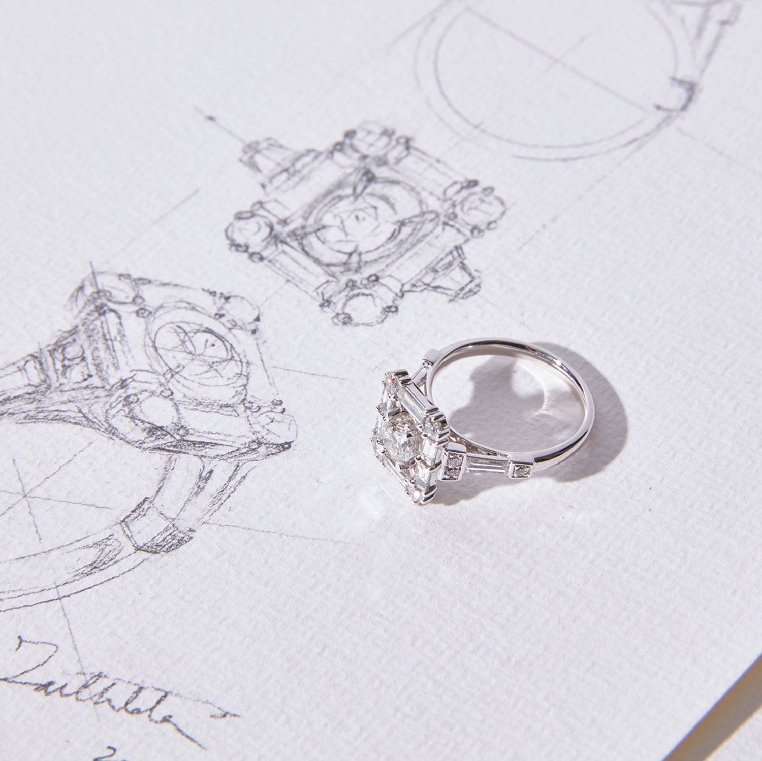 Grace aquamarine & diamond ring featuring a central diamond surrounded by baguette and brilliant-cut diamonds, set in a geometric Art Deco-inspired design