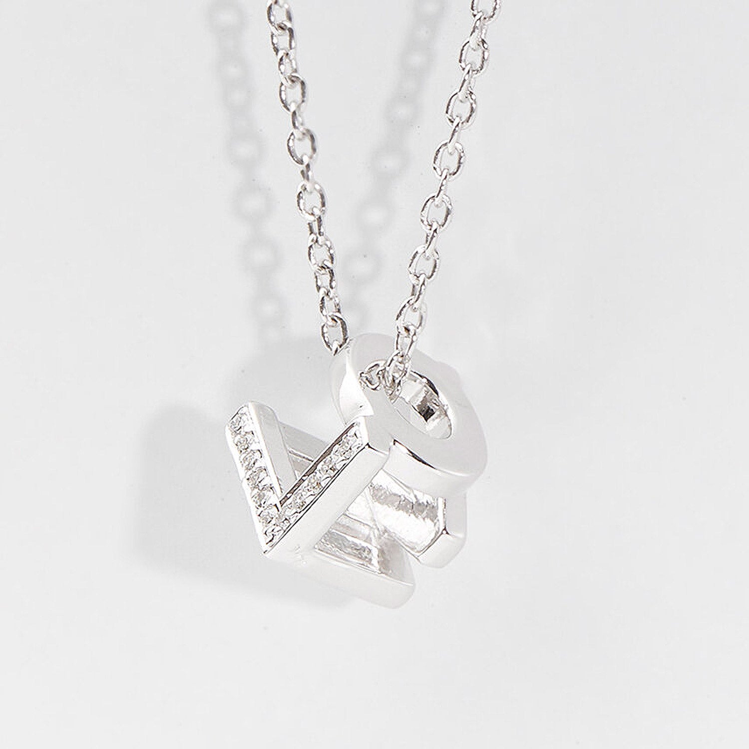 Bespoke Initial Cube Pendant Necklace featuring a love 3D cube design with initial L, O, V and E, suspended from a fine white gold trace chain