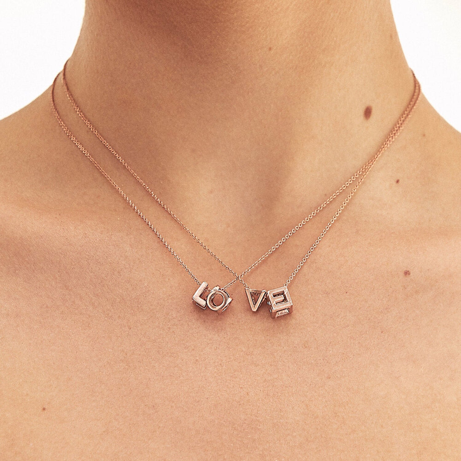 Bespoke Initial Cube Pendant Necklace featuring a love 3D cube design with initial L, O, V and E, suspended from a fine rose gold trace chain