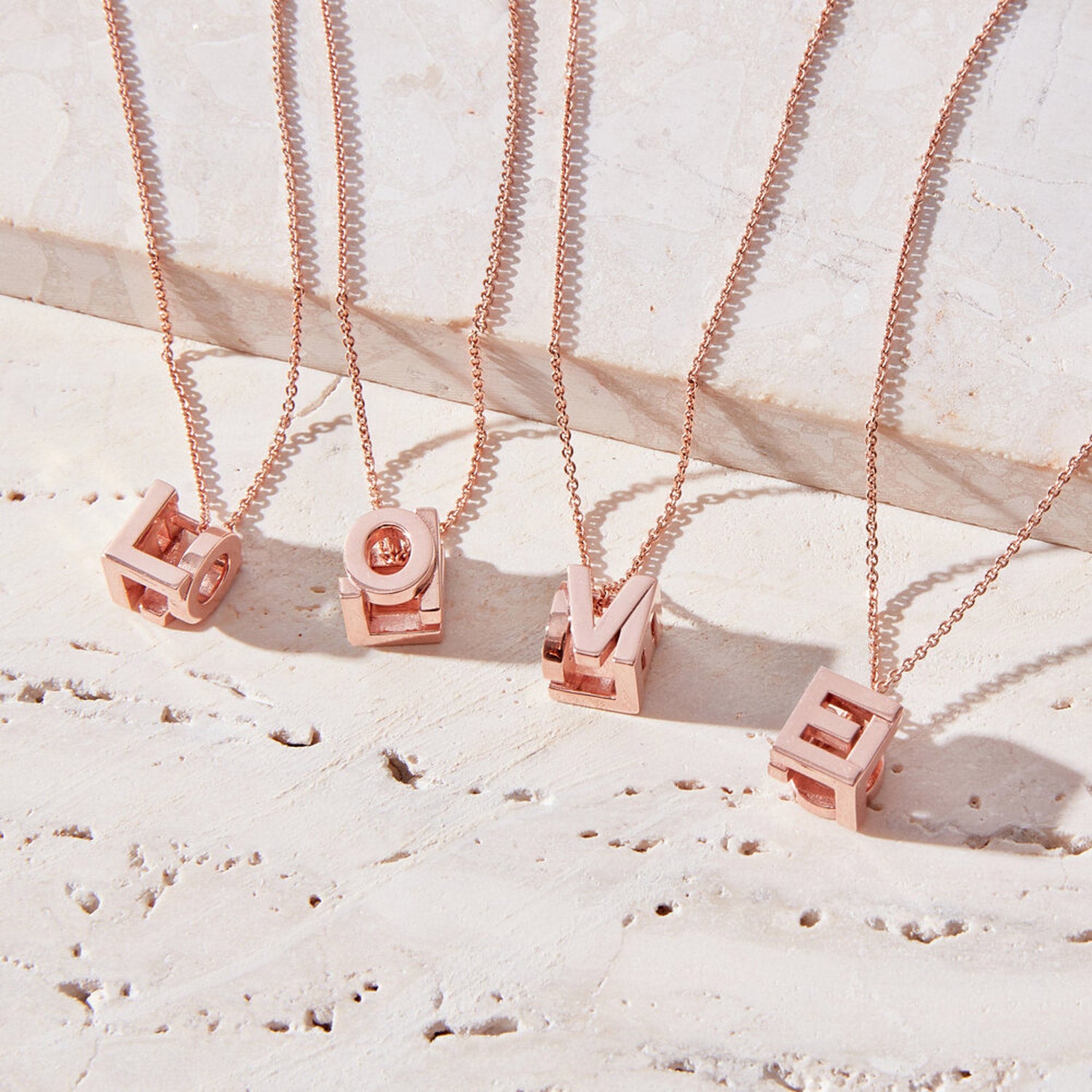 Bespoke Initial Cube Pendant Necklace featuring a love 3D cube design with initial L, O, V and E, suspended from a fine rose gold trace chain