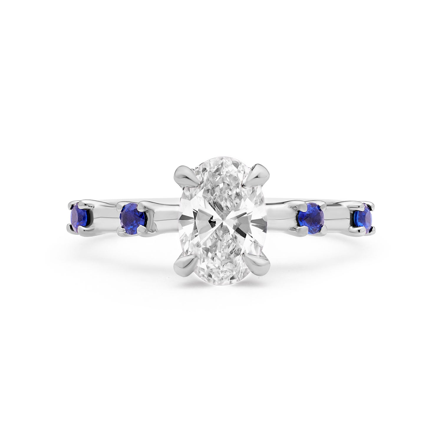 Faith Jewels Katherine blue sapphire and diamond engagement ring with a central oval-cut white diamond, accented by four blue Ceylon sapphires on an 18k white gold band.