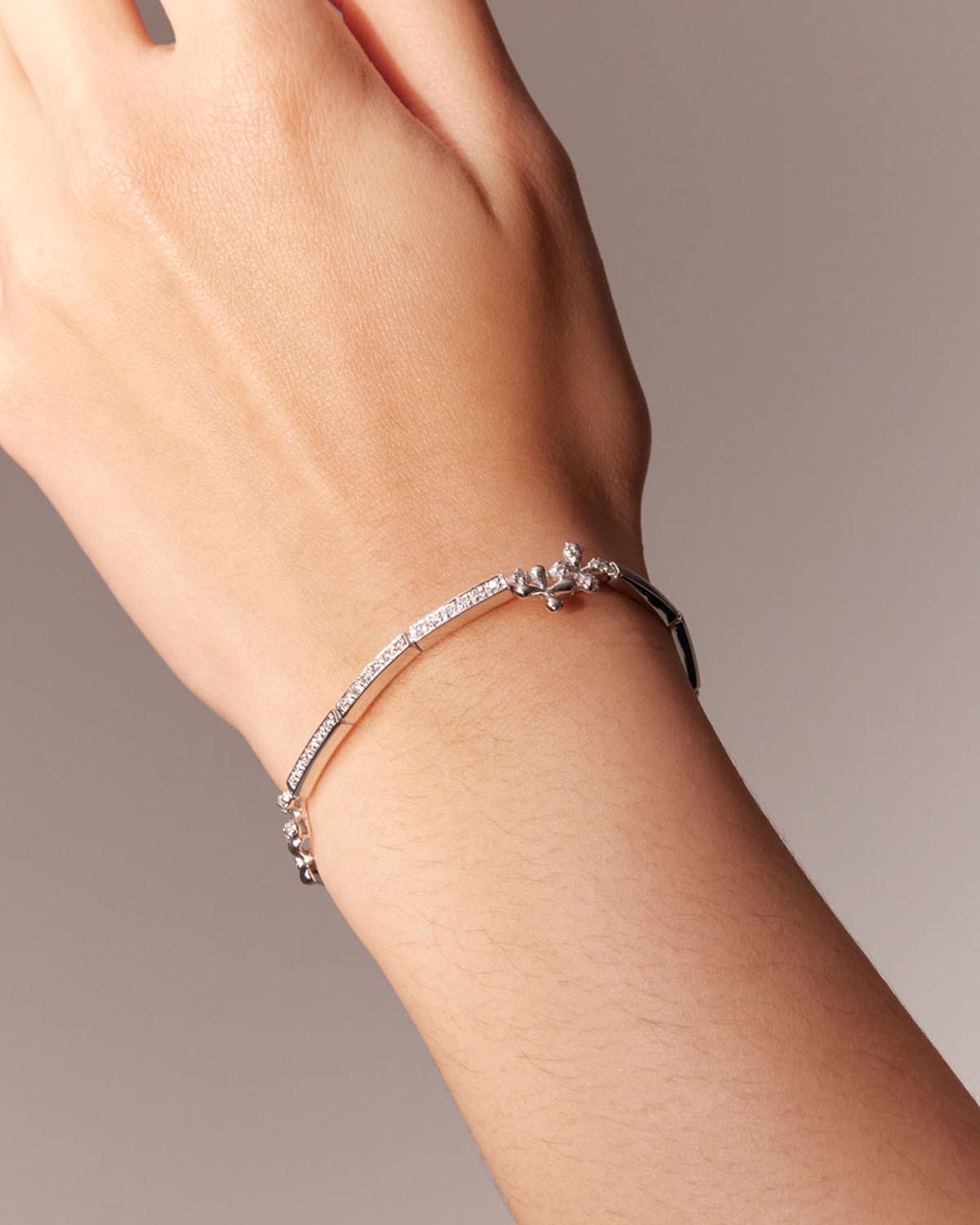 Wildflowers Diamond Bracelet in 18k white gold with 0.50ct diamonds and stylised floral motifs, worn on model.