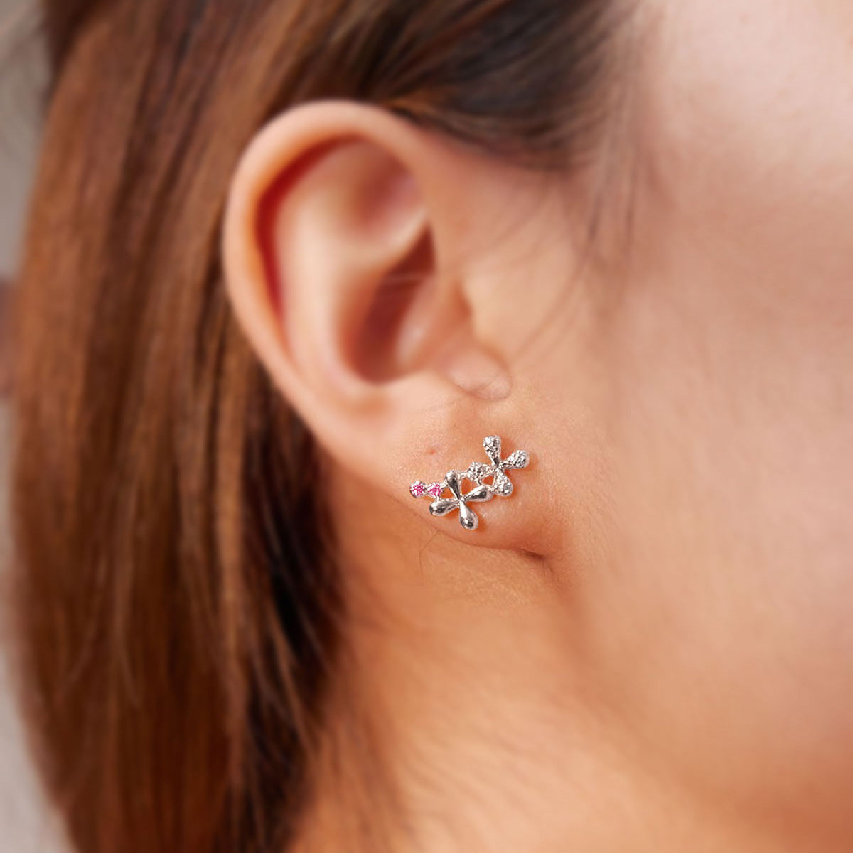 Wildflowers Collection Medium Pink Sapphire Stud Earrings with diamonds, and pink sapphires, 18k white gold, delicate floral motif, worn on model.