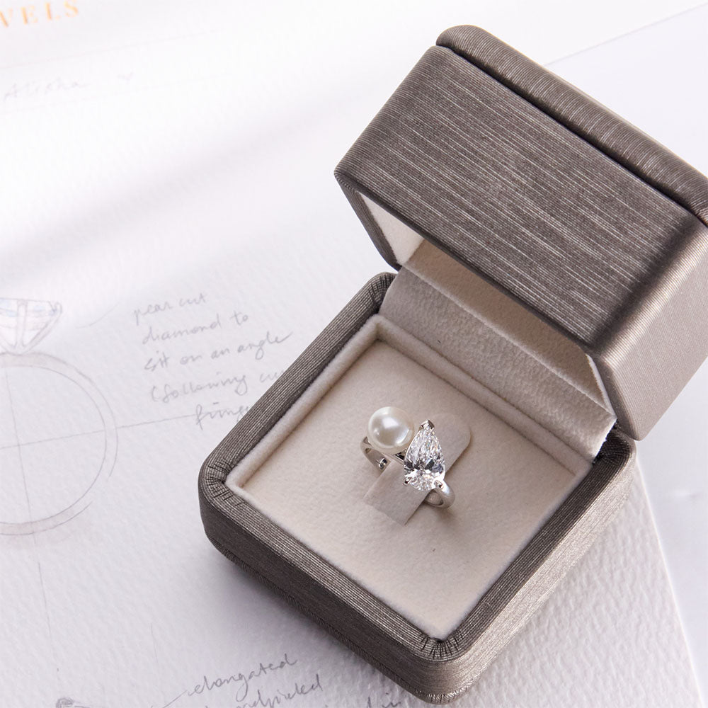 Faith Jewels bespoke ring featuring a hand-shucked pearl paired with a pear-cut diamond in a Toi Et Moi design.