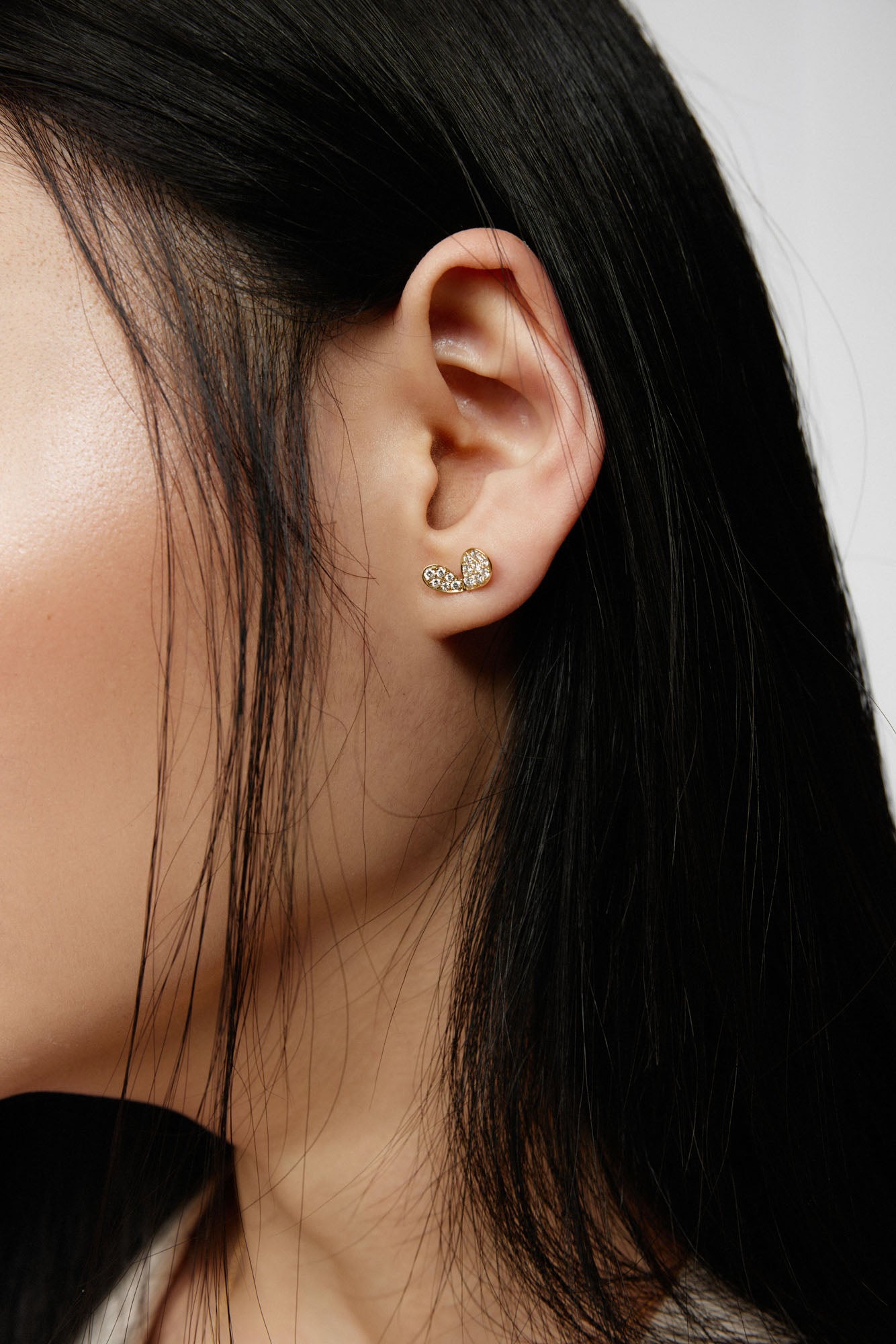 Faith jewels Diamond pavé yellow gold stud earrings in a stylized petal design, evoking hearts, butterflies, or wings