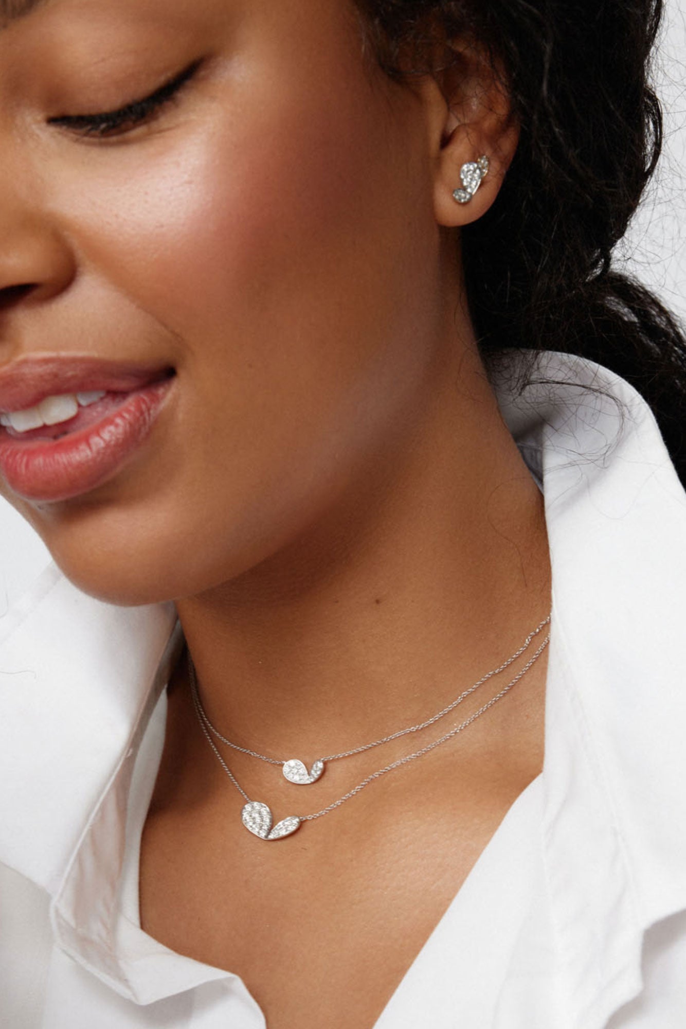 Faith Jewels 18k white gold necklace with a mini pavé diamond lily petal motif in two different sizes, worn with matching studs