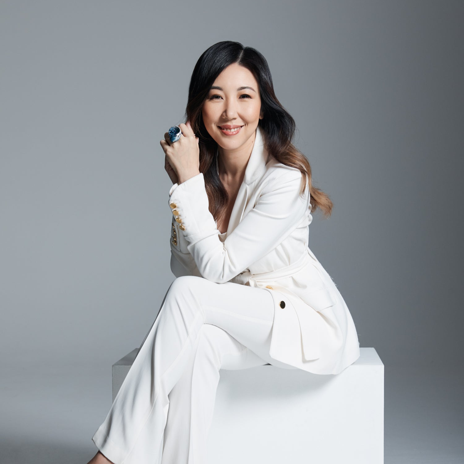 Profile of creative director Faith Hilda in a sitting position wearing the wave ring