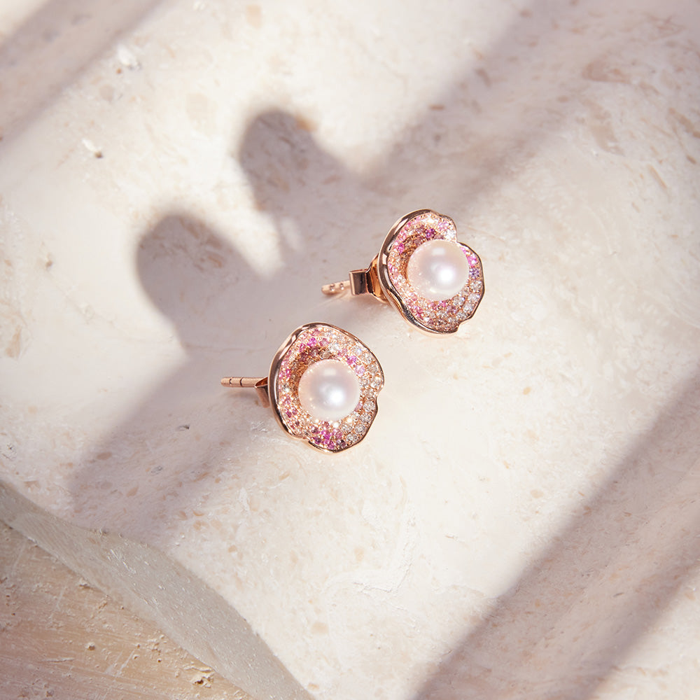 Faith Jewels Rose gold ring and earrings set with a central pearl, pink and white pavé diamonds, and petal-like design.