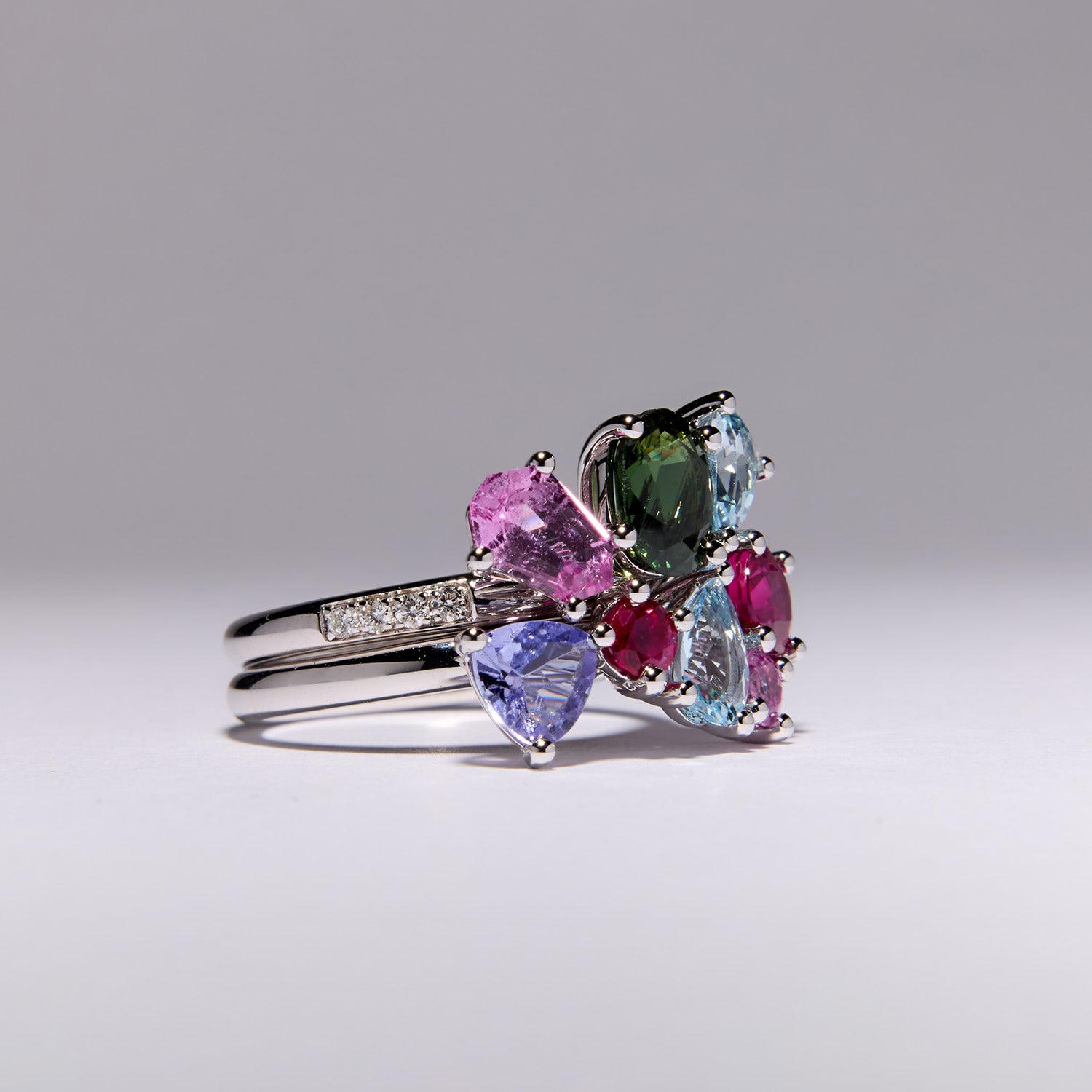 Heirloom Celestial Stack Ring in white gold with sapphires, rubies, tanzanite, topaz, and diamonds, interlocking celestial-inspired design.