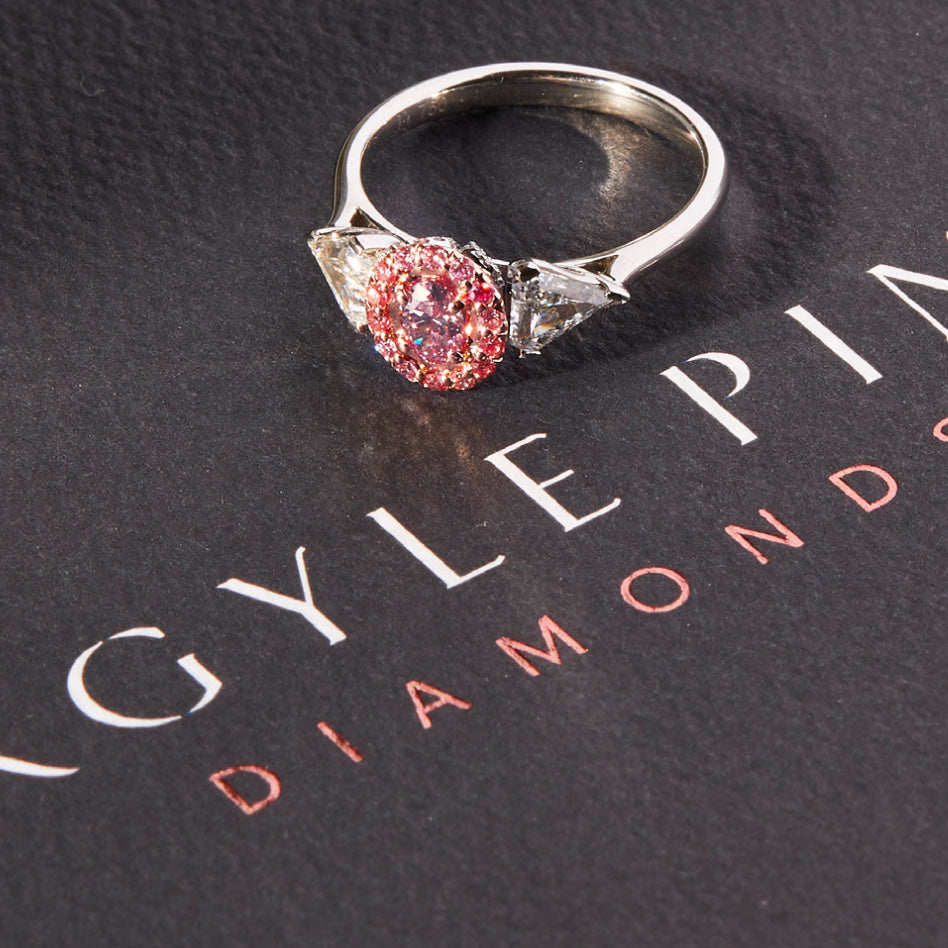 Rose diamond engagement Ring with Australian Argyle pink diamond, halo of pink diamonds, and kite-shaped white diamonds.