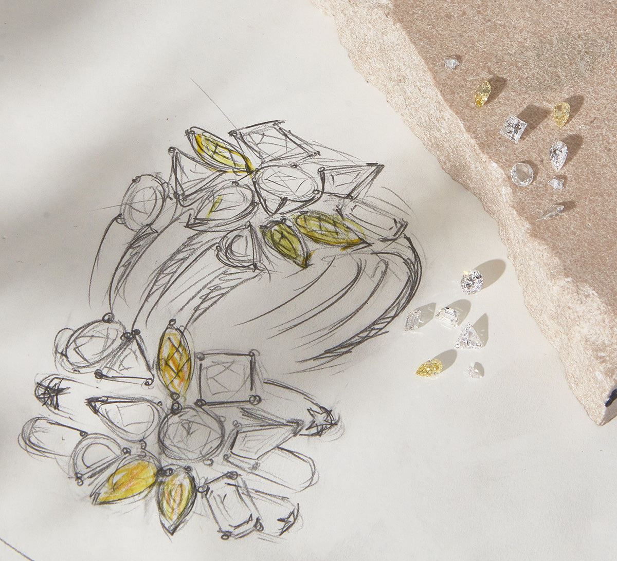 Jewelry design sketch with gemstones on a white surface to illustrate how to stack rings