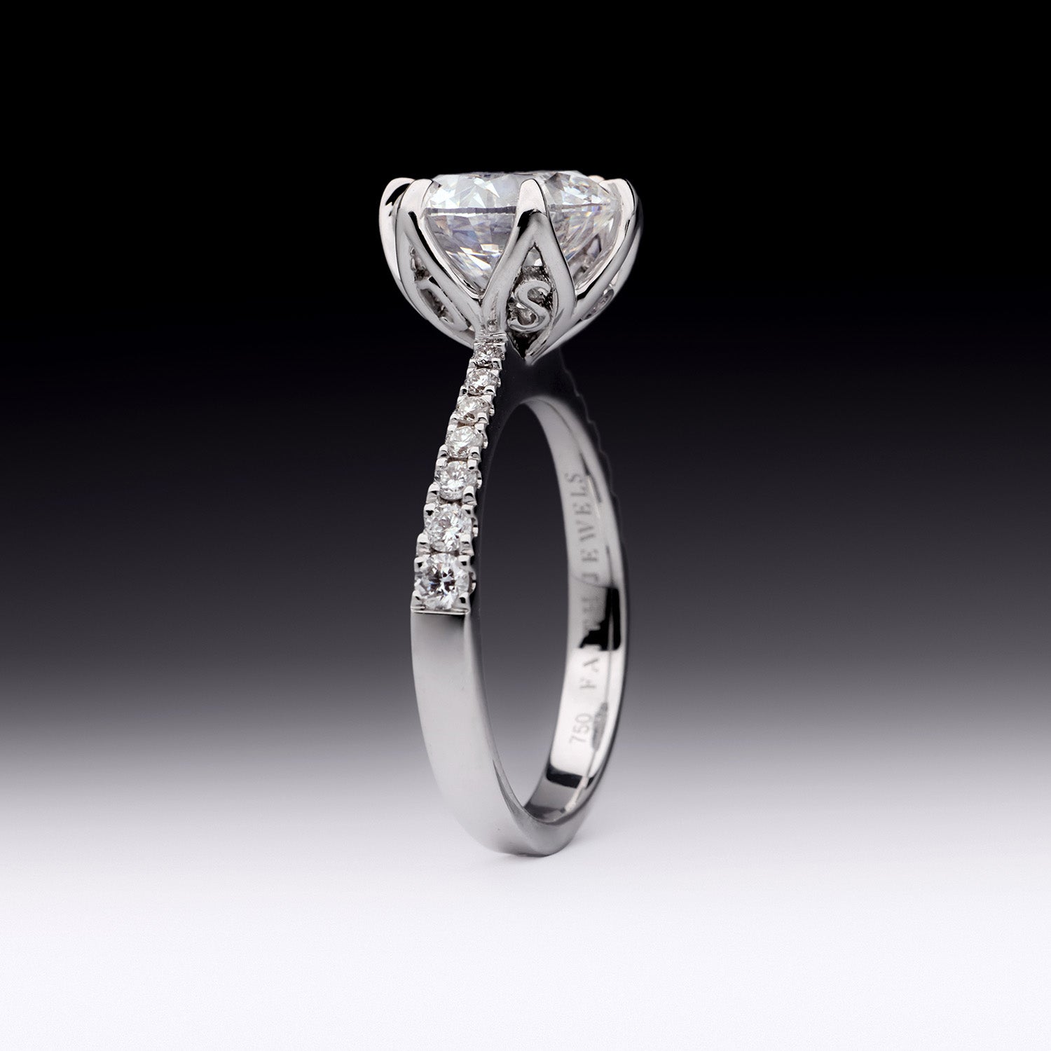 Sylvia diamond engagement ring with round brilliant-cut center stone and pavé band in white gold by Faith Jewels with "J" and "S" initials.