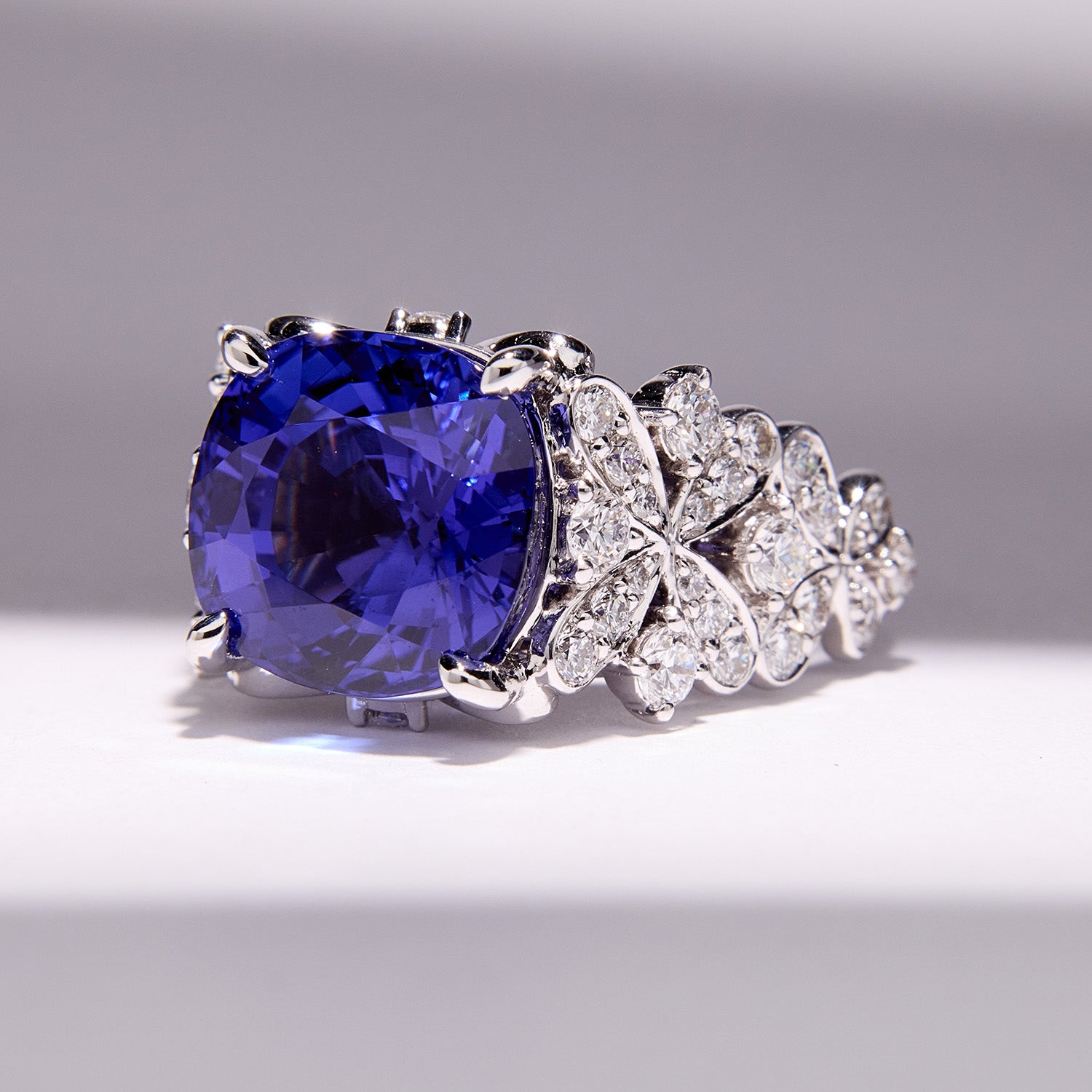 Bespoke tanzanite ring with floral-inspired white diamond accents, set in white gold