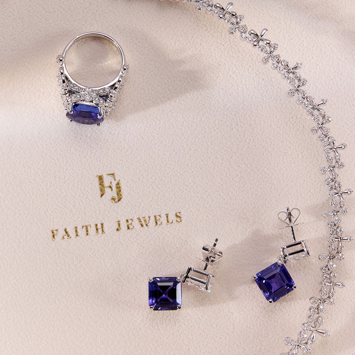 Bespoke tanzanite ring and matching earrings with floral-inspired white diamond accents