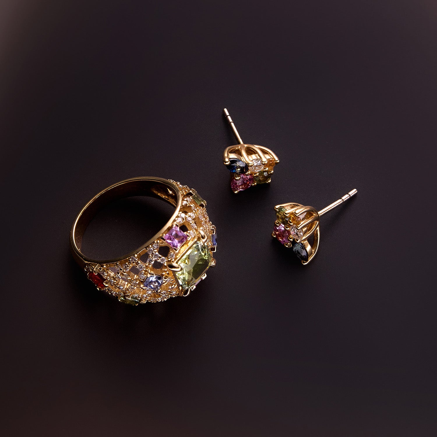 Statement dome gold ring and earrings featuring pink, blue, orange, and green gemstones with sparkling diamonds, bold and colourful design.