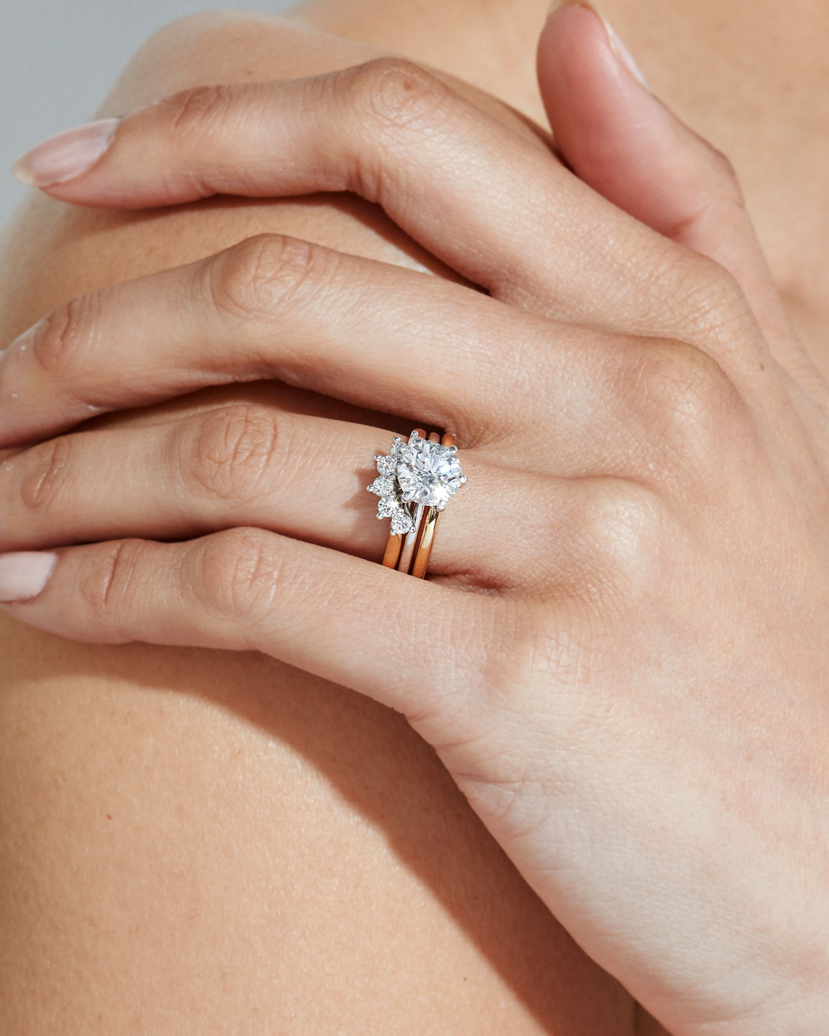 Faith Jewels Chantelle Ring stacked with yellow gold wedding bands, showcasing a timeless round brilliant solitaire design with a sleek six-prong setting