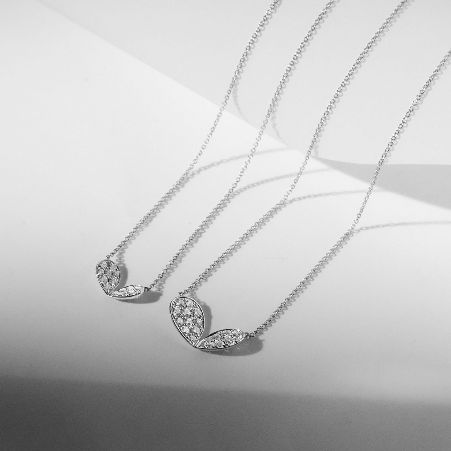 Faith Jewels 18k white gold necklace with a mini pavé diamond lily petal motif (0.30ct); adjustable chain length of 45cm or 40cm, in two different sizes