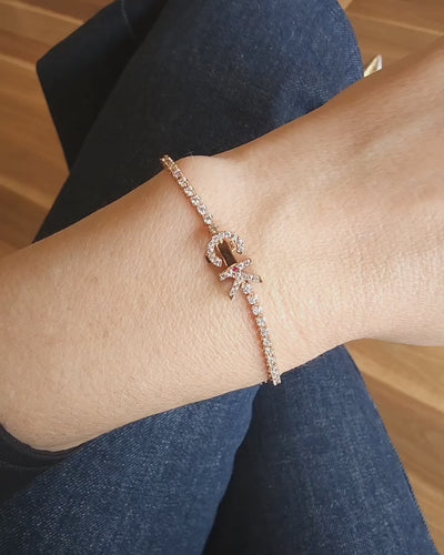 Faith Jewels bespoke initial diamond tennis bracelets in rose gold, each featuring a unique clasp shaped as a letter C and K — set with round brilliant-cut diamonds and red ruby