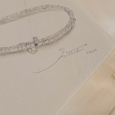Faith Jewels bespoke initial diamond tennis bracelets in white gold, each featuring a unique clasp shaped as a letter J — set with round brilliant-cut diamonds and blue sapphire