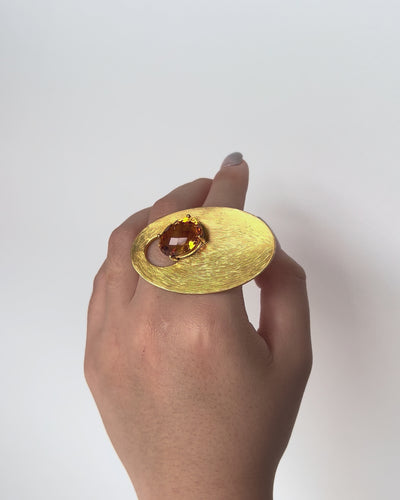 Cosmos Citrine Ring in 9k yellow gold with 12.28ct faceted citrine, curvilinear design inspired by orbital and gravitational forces, worn on hand model.
