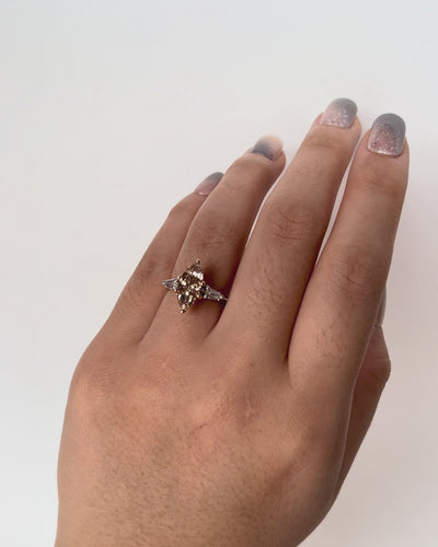 Unique Lotus Champagne Diamond Engagement Ring with 3.01ct marquise diamond in rose and white gold, worn on hand model.